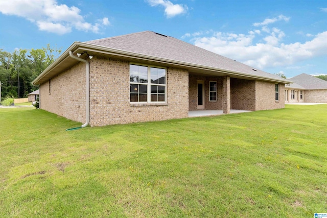 back of house featuring a yard and a patio