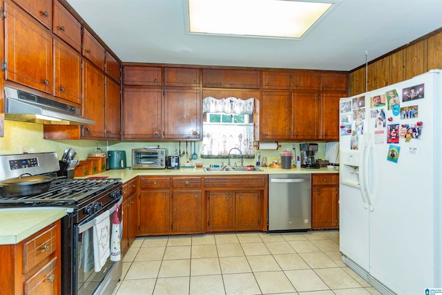 kitchen featuring light tile patterned flooring, sink, and stainless steel appliances