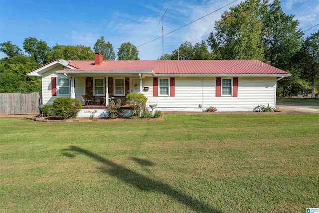 ranch-style home with covered porch and a front yard