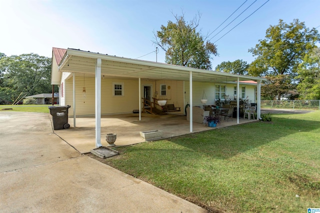 rear view of property featuring a yard and a patio