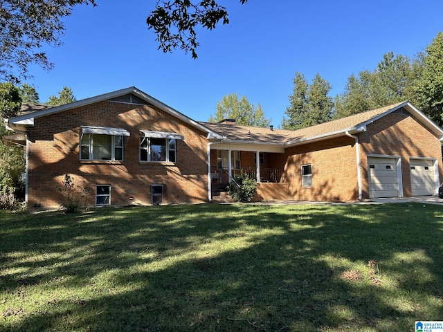 ranch-style home with a garage and a front lawn