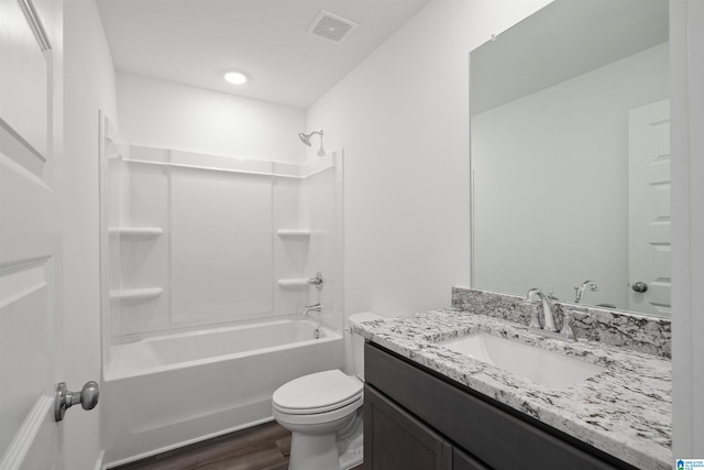 full bathroom featuring hardwood / wood-style floors, vanity, toilet, and  shower combination