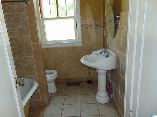 2820 20th St, Ensley, Birmingham, AL 35208 - full bathroom with tile walls, toilet, a tub to relax in, and tile patterned floors