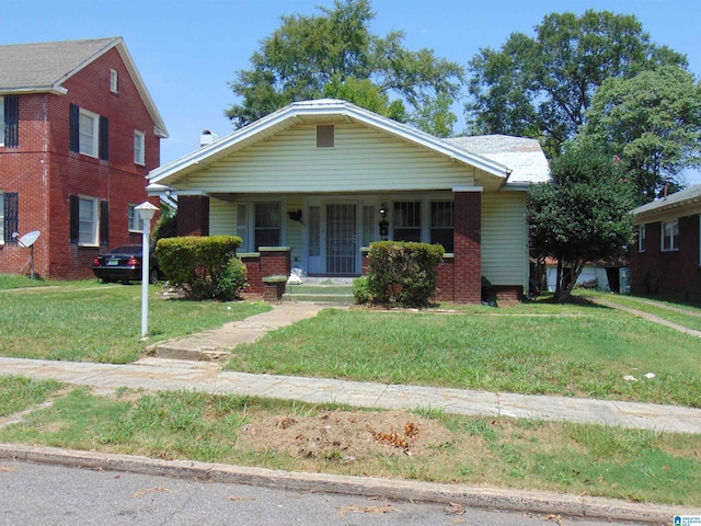 2820 20th St, Ensley, Birmingham, AL 35208 - view of front of house with covered porch, a front lawn, and brick siding