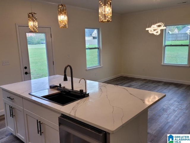 kitchen featuring white cabinetry, a center island with sink, decorative light fixtures, light stone countertops, and dishwashing machine