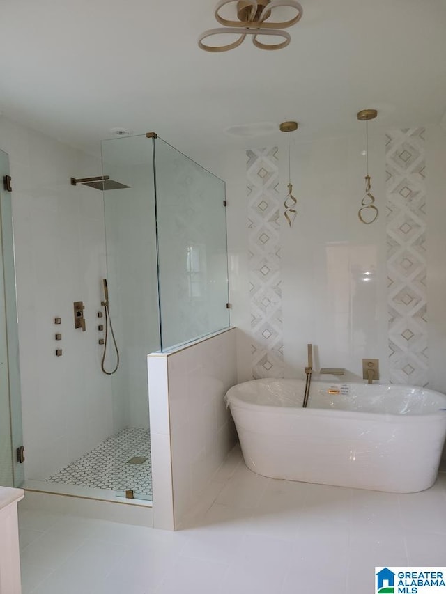 bathroom featuring tile patterned flooring and separate shower and tub