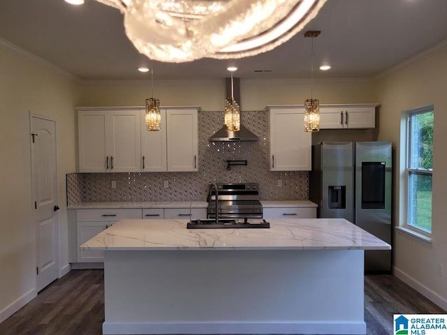 kitchen featuring wall chimney range hood, white cabinetry, an island with sink, sink, and light stone counters