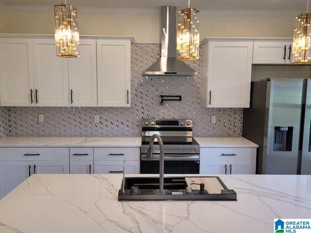 kitchen featuring decorative backsplash, hanging light fixtures, appliances with stainless steel finishes, and wall chimney exhaust hood