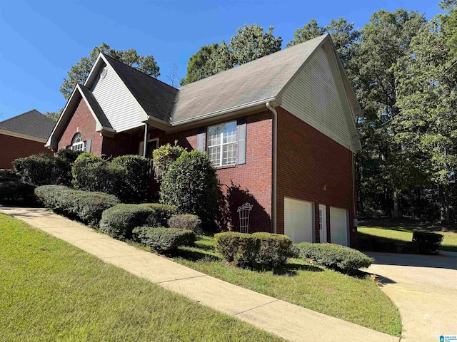 view of property exterior with a garage and a lawn