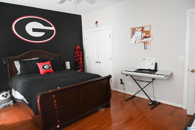 bedroom with ceiling fan, a closet, and hardwood / wood-style floors