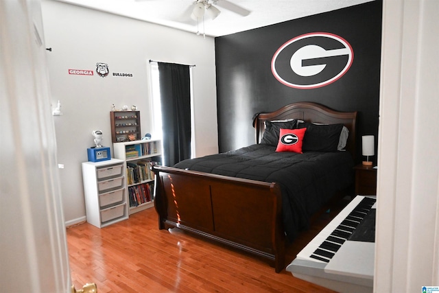 bedroom with wood-type flooring and ceiling fan