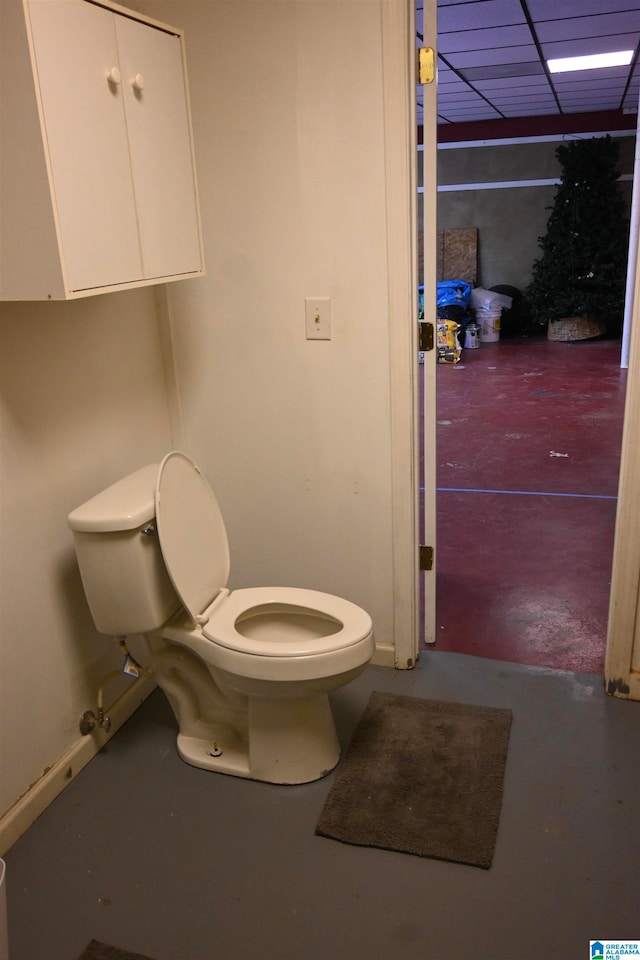 bathroom with concrete flooring and toilet