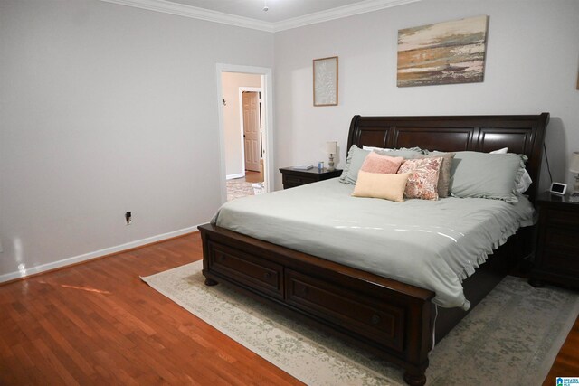 bedroom featuring crown molding and dark hardwood / wood-style flooring