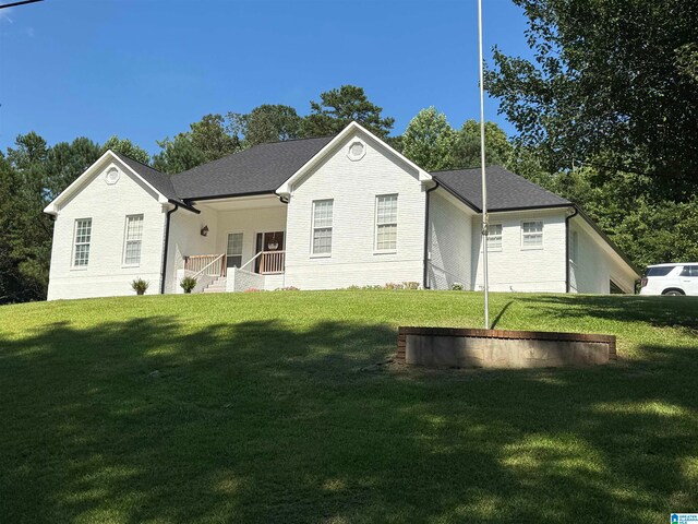 rear view of property with a yard