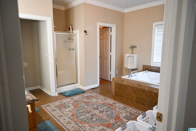 bathroom with tile patterned flooring, plus walk in shower, ornamental molding, and vanity