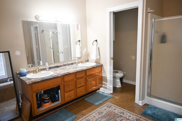 bathroom with tile patterned flooring, vanity, walk in shower, and toilet