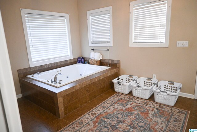 bathroom featuring tile patterned floors and tiled bath