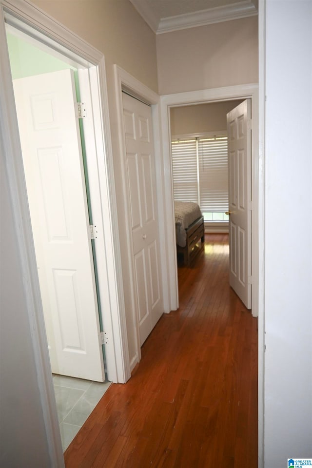 hallway with ornamental molding and hardwood / wood-style flooring