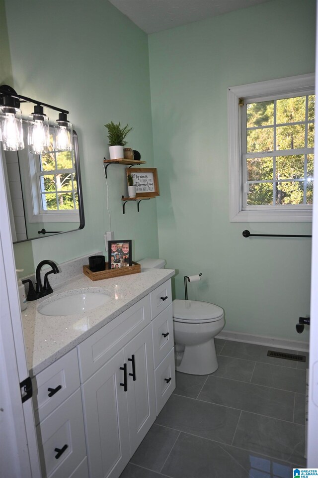 bathroom with tile patterned floors, vanity, and toilet