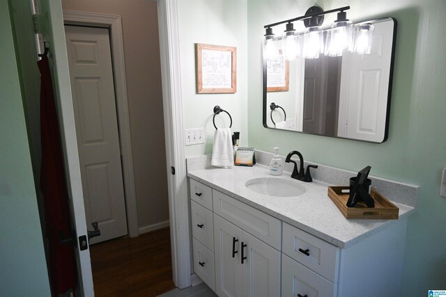 bathroom with hardwood / wood-style floors and vanity