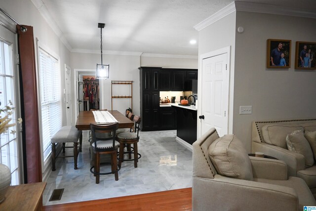 dining room featuring light wood-type flooring and ornamental molding