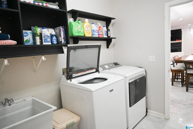 washroom with washer and clothes dryer and sink