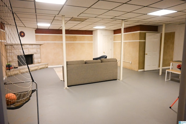 unfurnished living room with a stone fireplace and concrete flooring