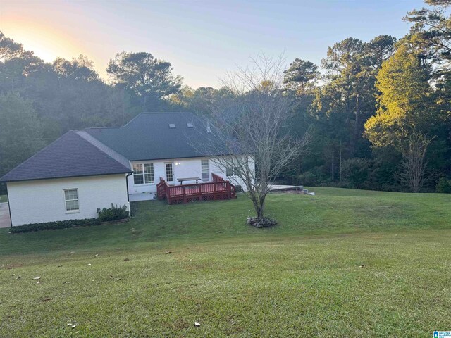 yard at dusk with a wooden deck