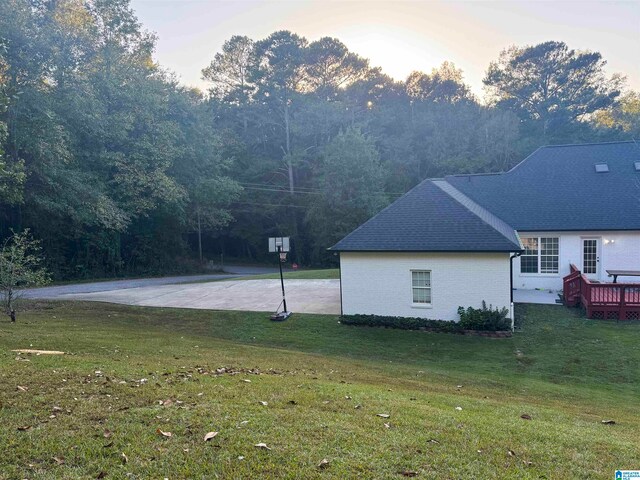 exterior space with a deck and a yard