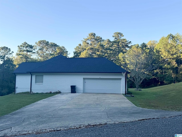 view of home's exterior featuring a garage and a yard