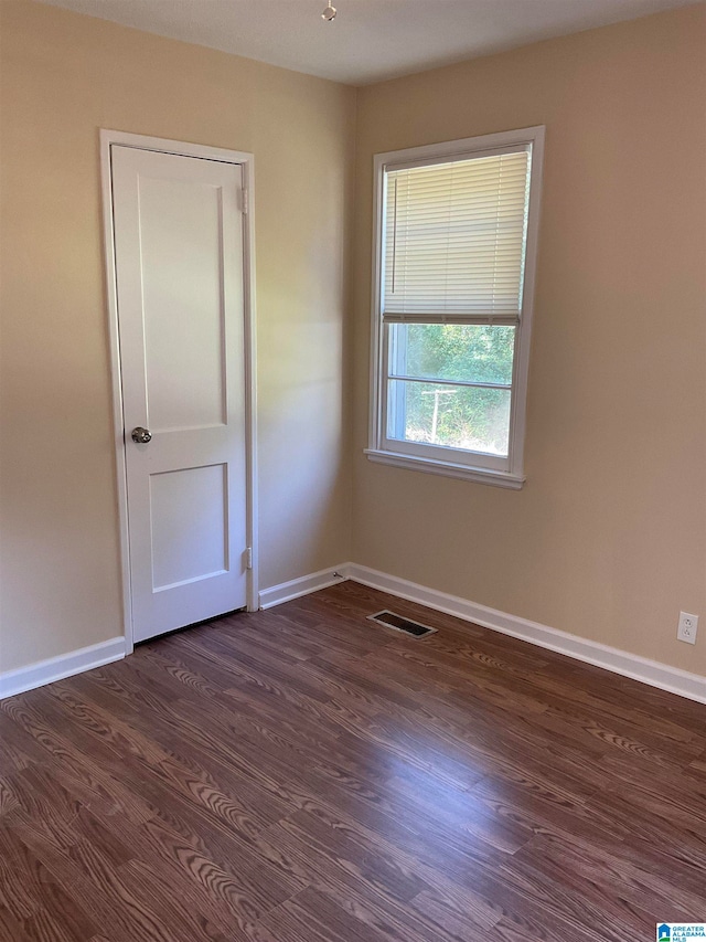 spare room featuring dark hardwood / wood-style floors