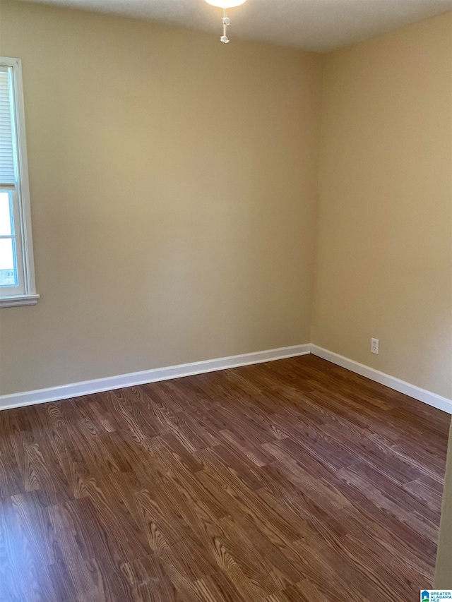 empty room featuring dark hardwood / wood-style flooring