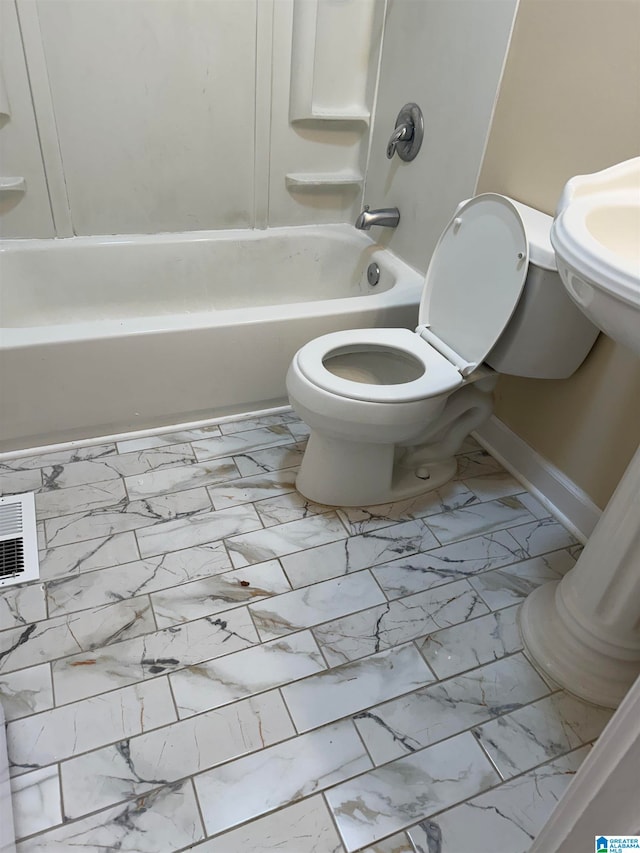 bathroom featuring shower / bath combination and toilet