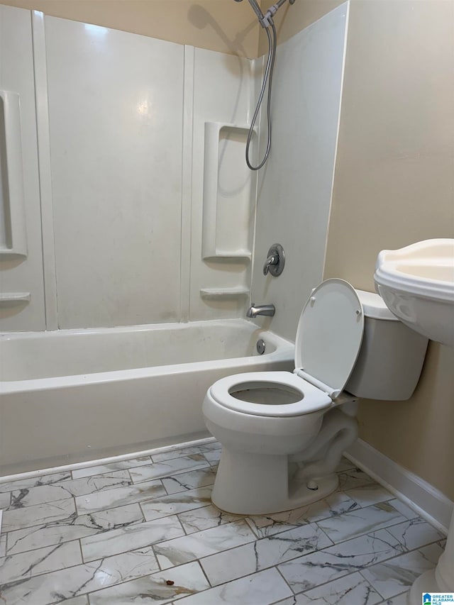 bathroom featuring shower / tub combination and toilet