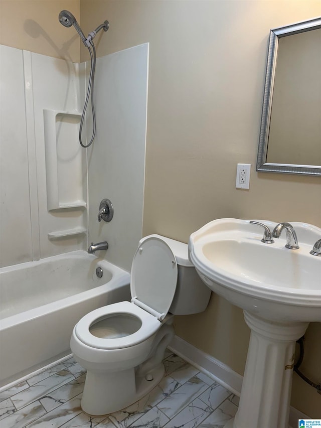 bathroom featuring shower / tub combination and toilet