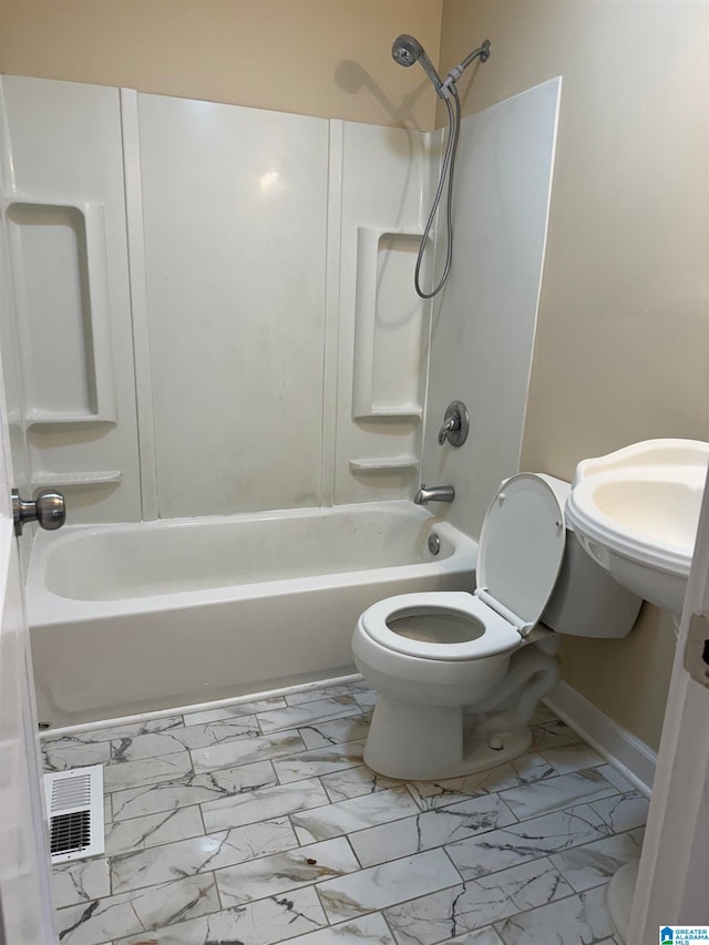 bathroom with bathtub / shower combination and toilet