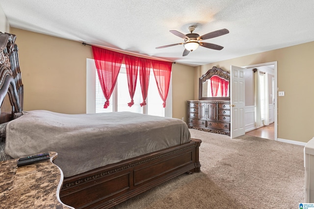 bedroom featuring carpet flooring, a textured ceiling, and ceiling fan