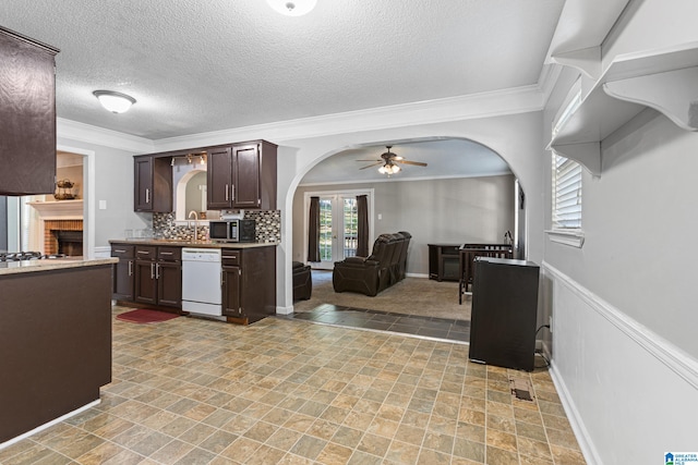 kitchen with dark brown cabinets, dishwasher, crown molding, and ceiling fan