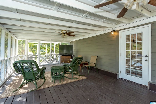 sunroom / solarium featuring ceiling fan