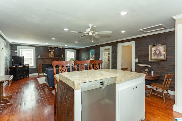 kitchen with dark wood-type flooring, plenty of natural light, dishwasher, and a kitchen island