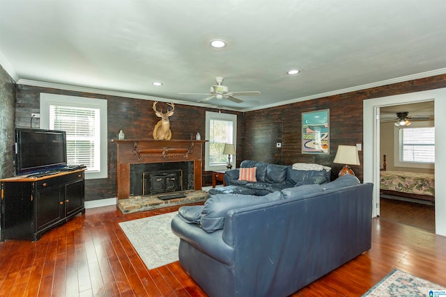 living room featuring crown molding, ceiling fan, and dark hardwood / wood-style flooring