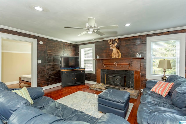 living room with ornamental molding, ceiling fan, and dark hardwood / wood-style flooring