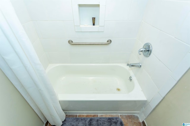 bathroom with tile patterned flooring and a washtub