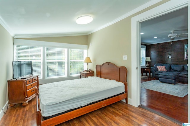 bedroom with lofted ceiling, dark wood-type flooring, and ornamental molding