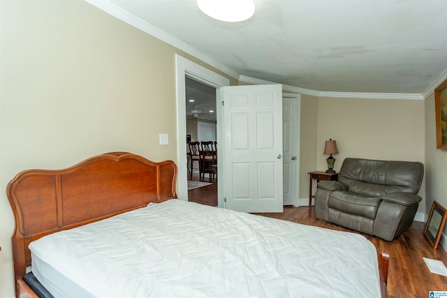 bedroom featuring ornamental molding and dark hardwood / wood-style flooring