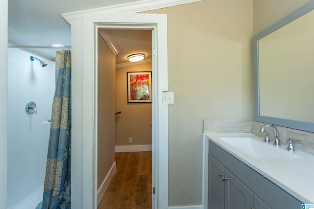 bathroom with lofted ceiling, a shower with shower curtain, vanity, wood-type flooring, and ornamental molding