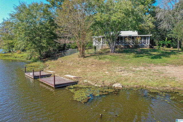 dock area with a yard and a water view