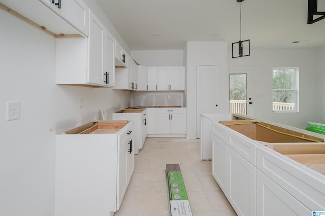 kitchen with white cabinets and decorative light fixtures