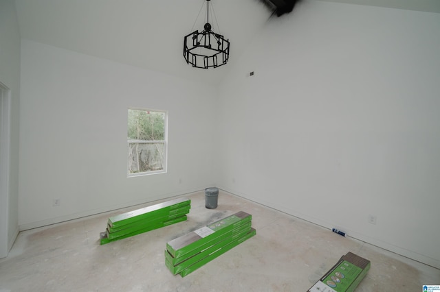 unfurnished room with high vaulted ceiling