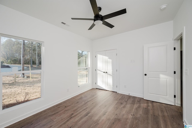 unfurnished room with ceiling fan and dark hardwood / wood-style flooring